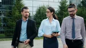 Colleagues walking and talking outside an office