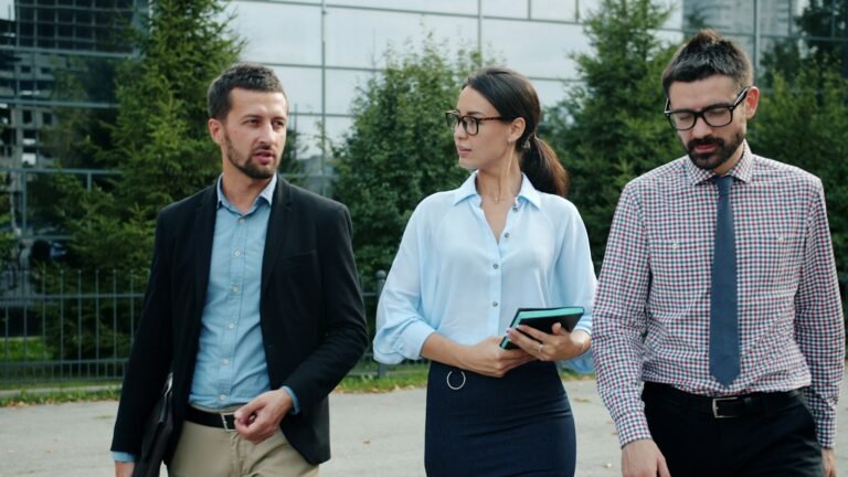 Colleagues walking and talking outside an office
